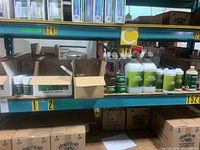 Shelf overview showing large green-label Ona liquid jugs, small gel canisters and various dispensers