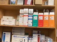 Top and bottom shelf view showing multiple unopened and partially used boxes of Hanna Instruments calibration solutions and accessories.