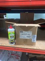 Opened box with one bottle outside and others visible inside box on shelf.
