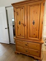 Front view of closed wardrobe showing two paneled doors above two drawers