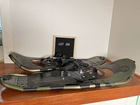 Pair of Tubbs Xplore 30 snowshoes displayed side by side, showing overall shape and design.