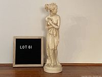 Front view of the Venus sculpture alongside a sign indicating lot number