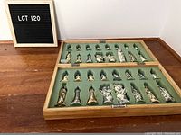 Full view of the open foldable chess board with 32 resin chess pieces arranged in recessed foam slots inside the wooden frame.