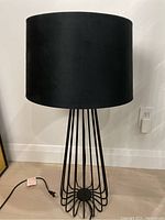 Front view of the Bowring black table lamp showing the wire base and drum shade.