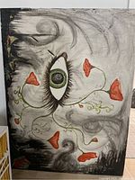 Full view of large acrylic painting showing eye, red flowers, gray and black swirls, with visible damage