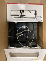 Canon Pixma iP2700 printer with cables inside packaging box