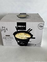 Closed box of the Boska Cheese Fondue Party Set in black showing branding and set image.