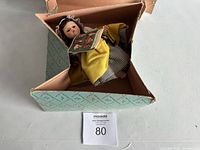 Doll posed inside original box showing box pattern and doll in full view.