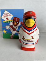 Front view of the St. Louis Cardinals ceramic stein with original colorful box in the background.