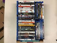 Wide view of two stacks of Blu-ray movies in cardboard box, including front horizontal discs.
