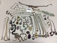 Overhead shot of all necklaces arranged on a white surface