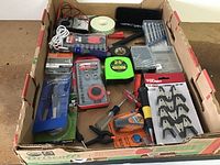 Full view of hand tools and accessories in cardboard box