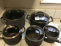 Cookware set showing all five pots with glass lids and various sizes