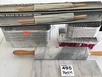 Overall display including boxed rolling pin, marble rolling pin, disposable bread tins and marble cutting board