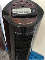 Close-up photo of fan top control panel and remote control placed on it