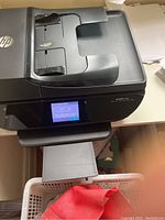 Front angled view of HP Envy 7640 printer showing paper feeder, touchscreen, and output tray.
