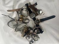 Image showing mixed lot of watches in various conditions, assorted straps and dial styles visible.