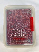 Top view of plastic case showing pixelated red design with text 'Pixel Cards Design by Pieter Woudt'