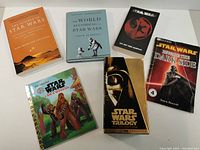 Display of all five Star Wars related books and the Special Edition VHS trilogy on a white surface.
