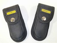 Two closed black nylon carrying cases with Stanley logo patch and metal snap closure