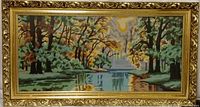 Front view of the embroidered art depicting a nature scene with trees, a river, and a sunlit sky in an ornate gold-colored frame.