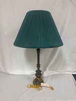 Full view of the vintage lamp with blue pleated shade and dark metal base showing overall condition.