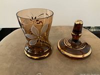 Amber glass candy dish without lid showing handpainted floral and gold decorative details