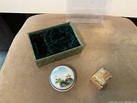 Lot items displayed including carved stone seal with red ink residue, round ceramic ink pot with landscape painting, and fabric-covered green box with velvet interior.