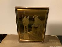 Framed metallic design photo featuring Gastown Steamclock and surrounding building in bronze/gold tones.