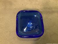 Top view of the square cobalt blue glass trinket dish showing the bullivante bubble pattern in the glass.