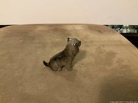 Clear, focused photo of the Royal Doulton wolfhound dog figurine showing the whole piece from side view on a brown surface.