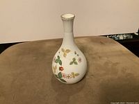 Front view of the white Wedgwood bud vase with wild strawberry botanical illustrations and gold rim detail.