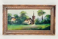 Full view of the antique reverse painted on glass artwork showing a church and trees within a carved wooden frame.
