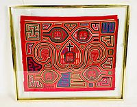 Full view of framed Kuna Mola embroidery textile art in gold frame under glass