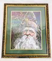 Full view of framed Santa Claus print showing the ornate gold frame and double mat under glass.