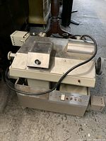 Front angled view showing control panel, power switch, and protective cutting shield on the key cutting machine.