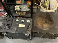 Black metal box unit with identification plate, showing condition and size
