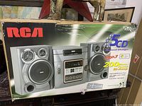 Front photo of RCA RS2652 stereo system box showing the stereo and speaker system illustration, highlighting the 5-CD carousel changer and 200 watt power bi-amp capabilities.
