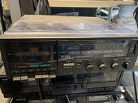 Front view of Yorx stereo cassette recorder showing AM/FM radio dial, cassette player, control knobs, and buttons.