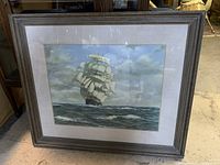 Photo showing the full framed ship artwork with wooden frame and matting.