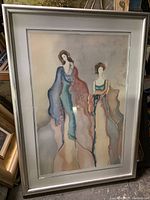 Framed abstract painting showing two elongated female figures in soft pastel colors, signed by the artist in lower right corner.