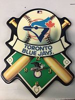 Front view of the Toronto Blue Jays themed clock showing baseball, bats, and team logo details
