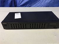 Front view of the Technics black stereo graphic equalizer SH-8017 showing multiple sliders and the Technics logo.