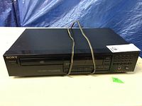 Front view of Sony CD player with visible controls and power cord on top.