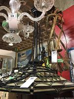 Photo of the stained glass hanging lamp showing the shade with geometric pattern and black metal chains for hanging.