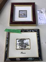 Two framed small repouss wall art pieces side by side showing full lot contents with size notes and label.