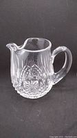 Front angled view of Waterford crystal pitcher showing handle and cut glass pattern.