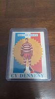 Front view of 1960-61 Topps Cy Denneny All-Time Greats hockey card in protective sleeve showing full color portrait of Cy Denneny.