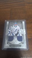 Front view of Andrei Vasilevskiy hockey card in protective case featuring dual jersey swatches and numbered 111/165.