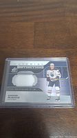 Front side of the Connor McDavid jersey card showing player image, team, and embedded swatch of white game-used jersey.